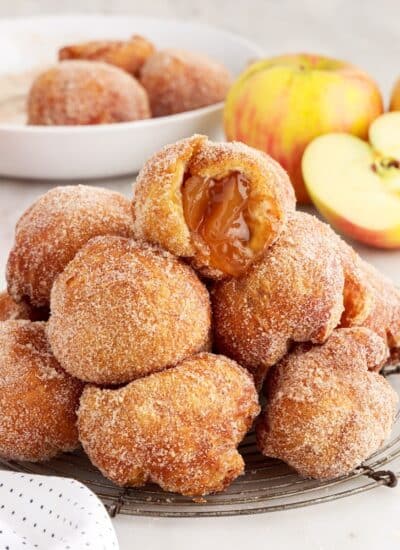 Apple Pie Bombs on a cooling trivet one cut open on the top.