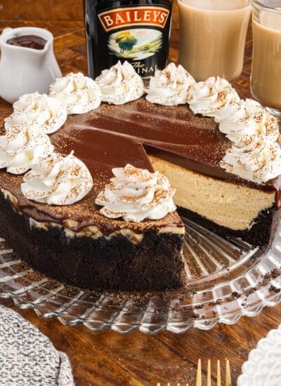 A slice of Bailey’s Cheesecake missing from a cheesecake.