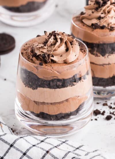 Layers of chocolate cookies, mousse, and Bailey's chocolate cheesecake in glasses.
