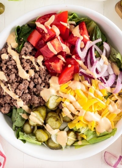 Top view of Big Mac Salad with dressing drizzled on top.