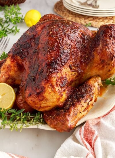 A Thanksgiving cajun turkey on a plate with a lemon half and garnish.