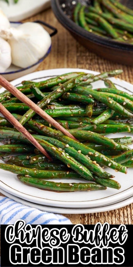 Chopsticks picking up Chinese buffet green beans from a plate.