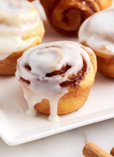 Mini Cinnamon Rolls on a plate with glaze.