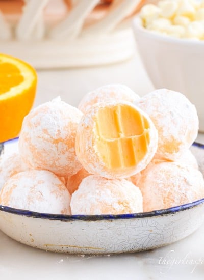 close up of orange creamsicle truffles one with a bite taken out