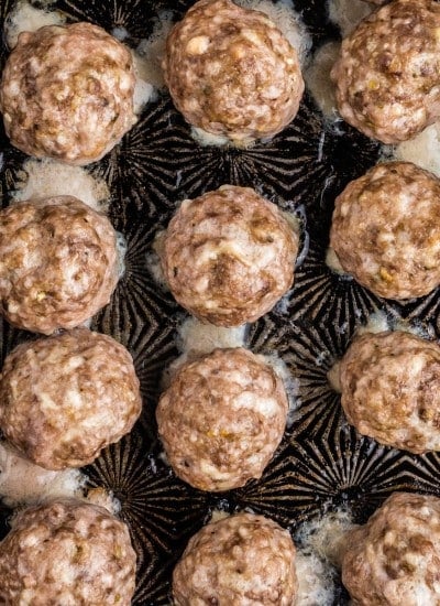 a baking sheet full of oven baked meatballs.