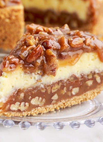 slice of caramel pecan pie cheesecake on a small plate