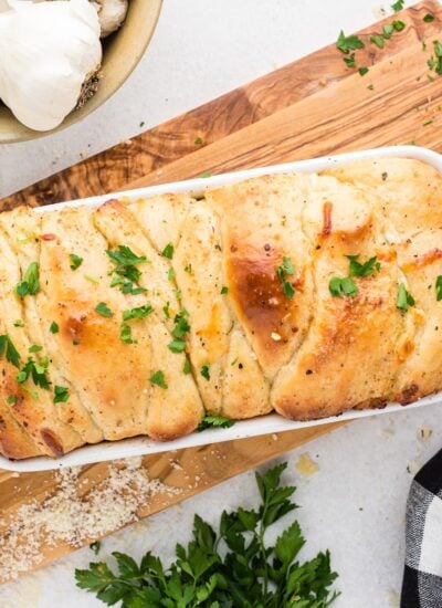 Pull apart garlic bread in a bread baking dish.