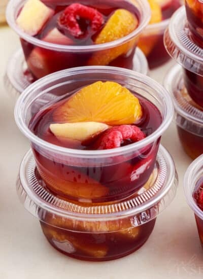 Stacks of Sangria jello shots in small plastic cups.