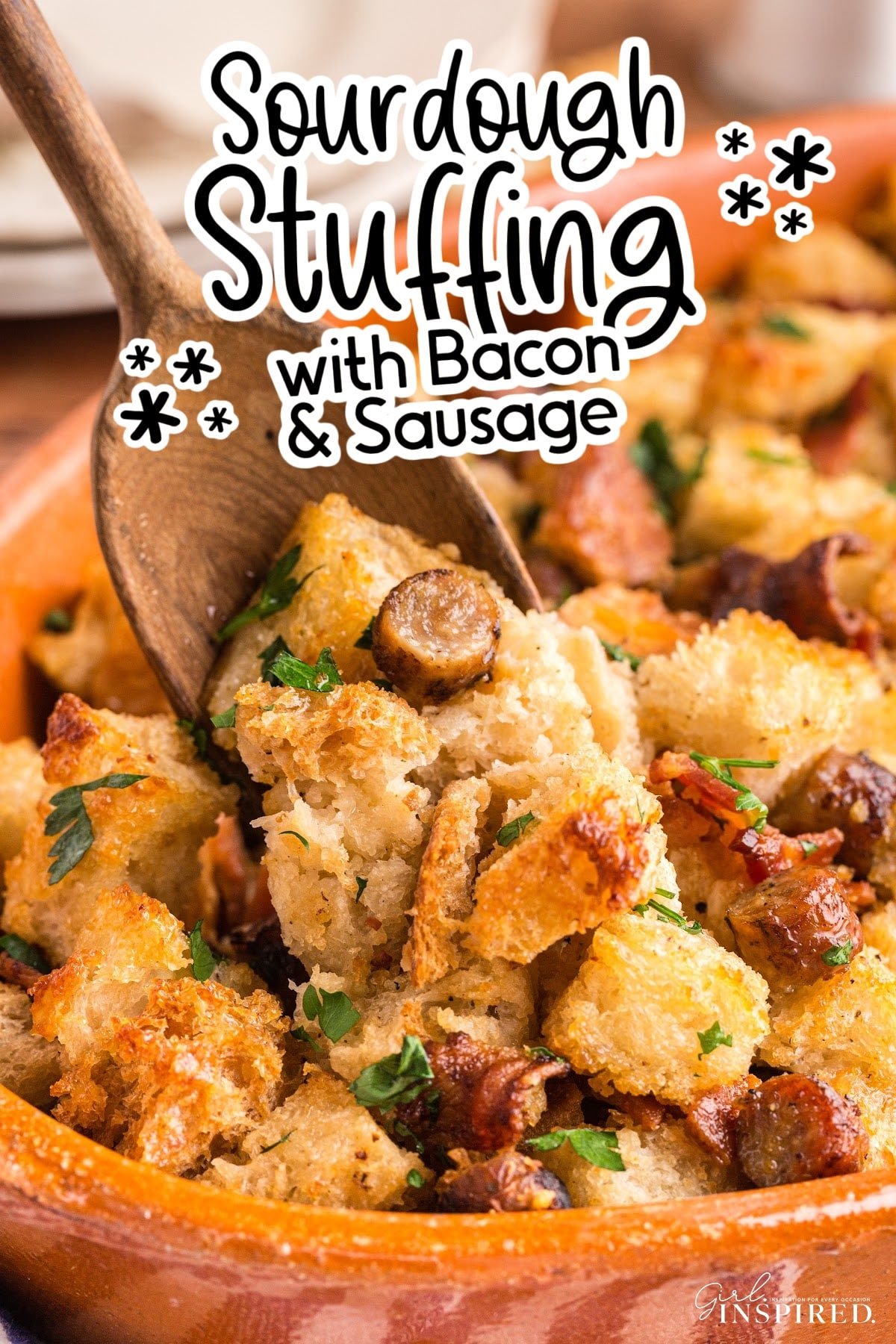 Sourdough stuffing with sausage with a wooden spoon dipping some out.