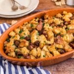 A large baking dish of sourdough stuffing with sausage.