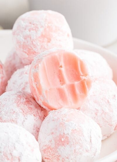 A stack of Strawberry Truffles with one on top with a bite out of it.
