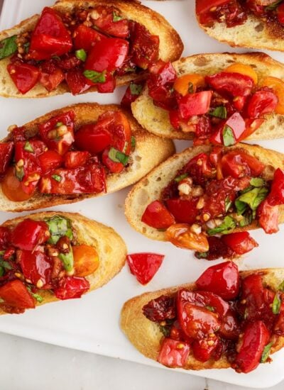 Sundried tomato bruschetta on a white serving tray.
