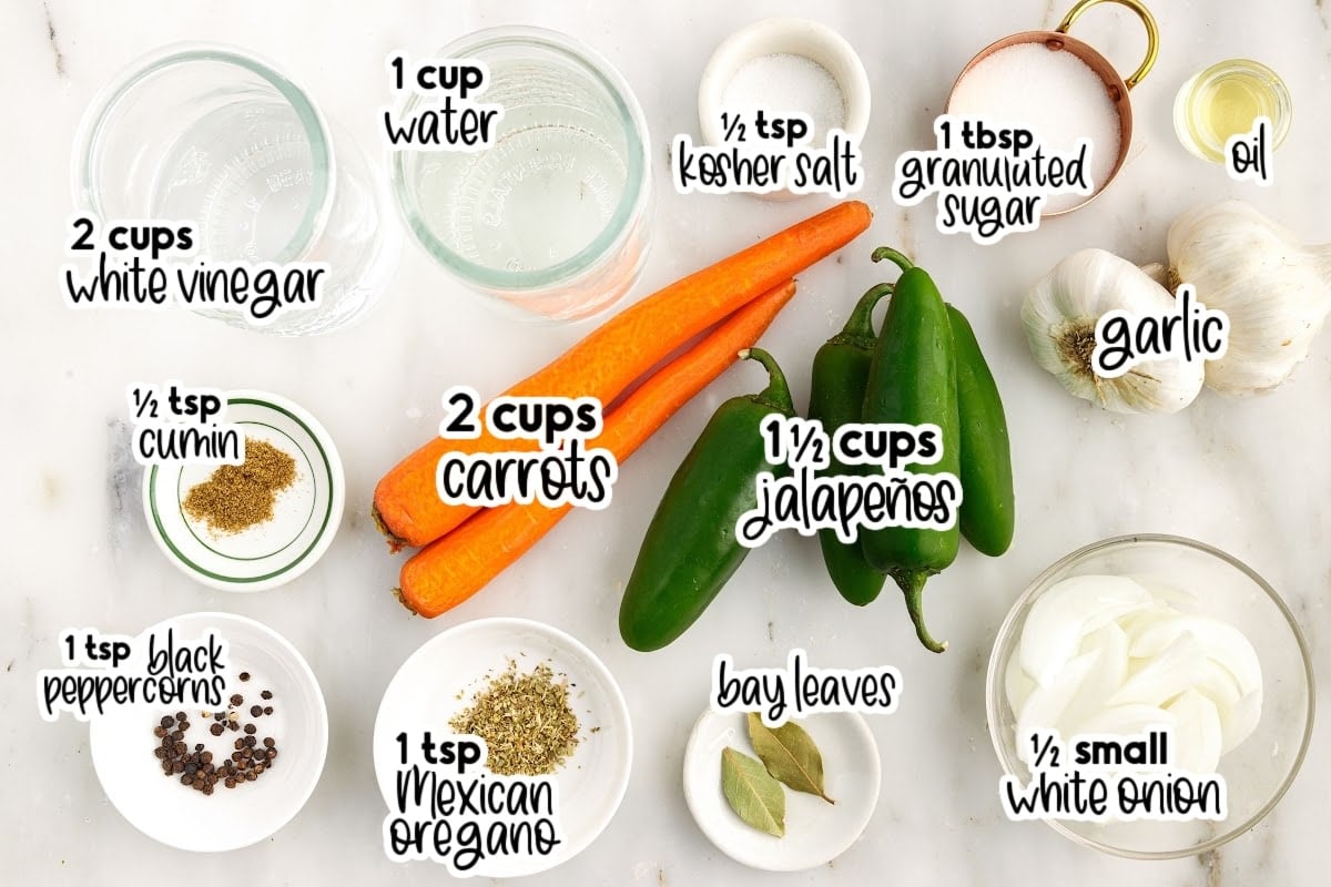 Ingredients needed to make Pickled Jalapeños and Carrots with text overlay.