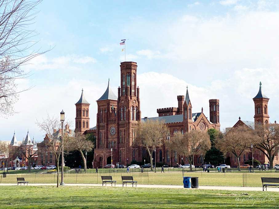 Park grass with red brick castle in the background