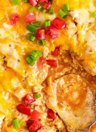 close up of a spoon in turkey enchilada casserole